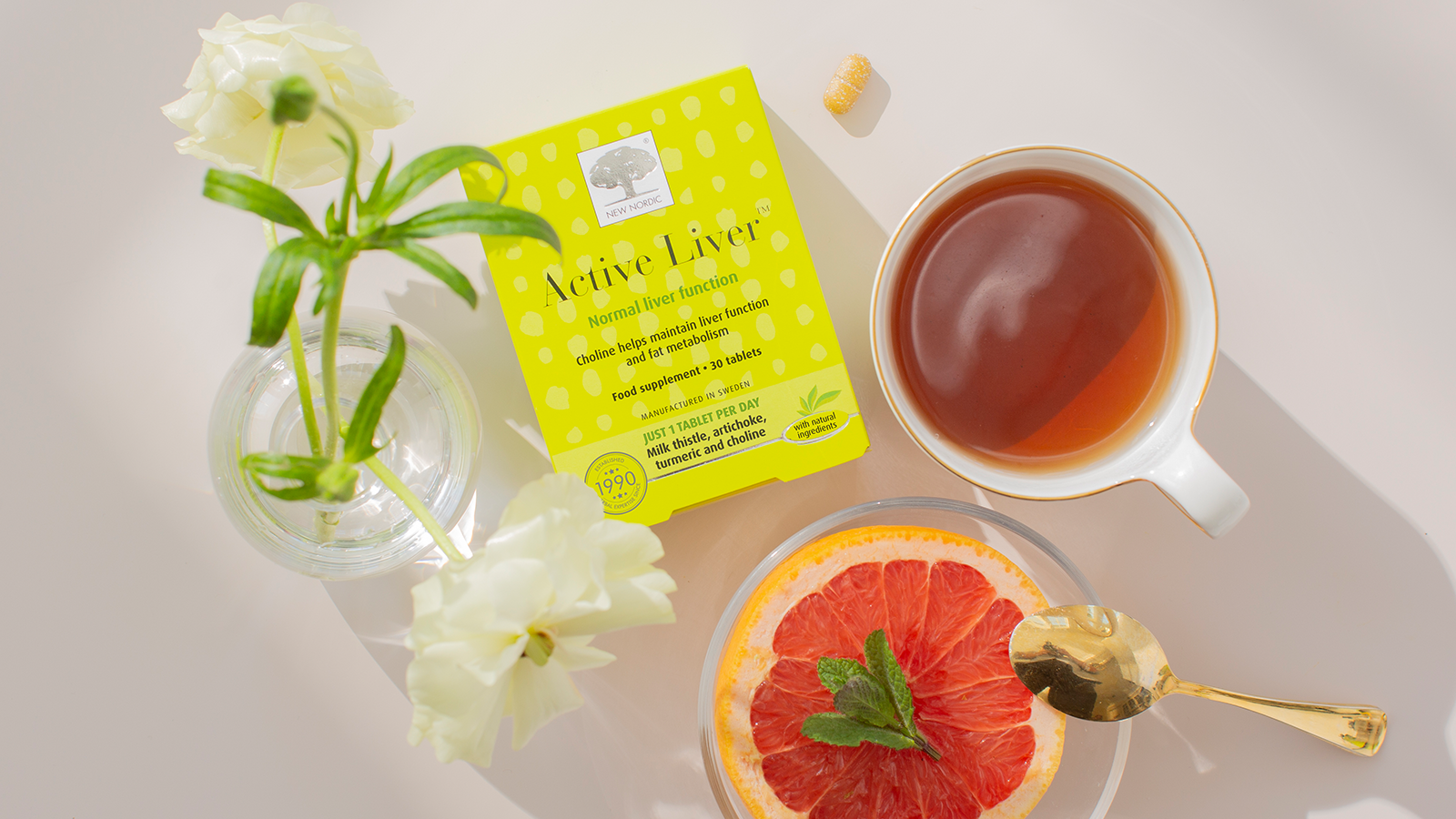Healthy outside starts from the inside 10 New Nordic Active Liver™ package displayed alongside some tablet ingredients on a light background